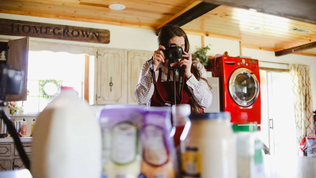 woman taking picture of ingredients on kitchen counter