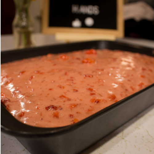 cake in pan with strawberry glaze
