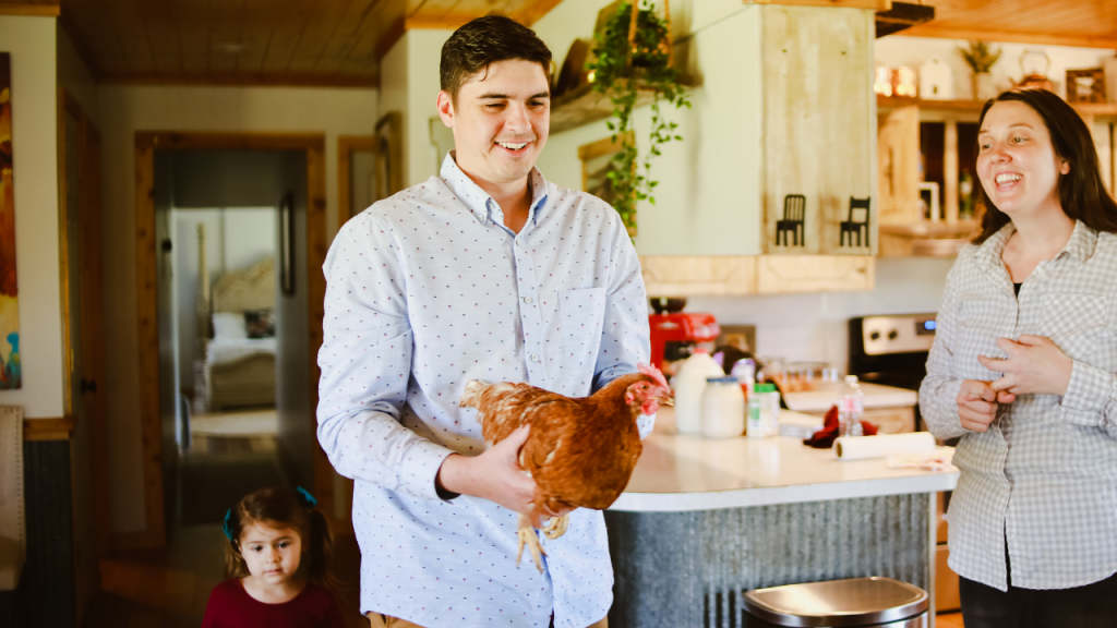 father in kitchen with chicken 