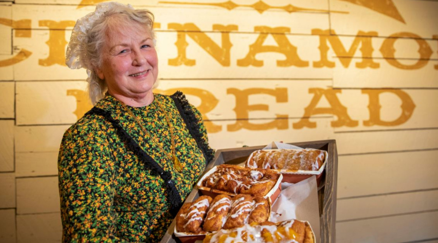 older lady holding baked breads